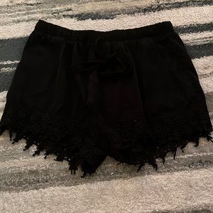 Black shorts, fringe at bottom, loose fitting